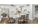 Charming kitchen with white cabinetry, granite countertops, a center island, and barstool seating at 11724 Easthampton Cir, Charlotte, NC 28277