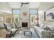 Spacious living room with high ceilings, a fireplace, and large windows providing ample natural light at 11724 Easthampton Cir, Charlotte, NC 28277