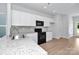 Modern kitchen with stainless steel appliances, granite countertops, and white cabinetry at 1225 Langston Ln, Salisbury, NC 28144