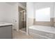 Bathroom featuring a separate shower, soaking tub and neutral tile at 1237 Langston Ln, Salisbury, NC 28144
