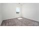 Bright bedroom featuring soft carpet, a window for natural light, and neutral wall paint at 1237 Langston Ln, Salisbury, NC 28144