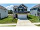 Charming two-story home featuring stone accents, a two-car garage, and a well-manicured lawn at 1237 Langston Ln, Salisbury, NC 28144