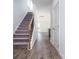 Inviting entryway featuring hardwood floors, a staircase with wood and iron railing and neutral walls at 1237 Langston Ln, Salisbury, NC 28144