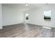 Bright, open living space featuring hardwood floors, two windows, and neutral walls at 1237 Langston Ln, Salisbury, NC 28144