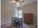 Comfortable bedroom featuring neutral tones, a ceiling fan, and ample natural light, complemented by functional furniture at 1242 Langston Ln, Salisbury, NC 28144
