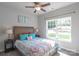 Bright bedroom with a large window, plush carpeting, and a ceiling fan, offering a comfortable and inviting space at 1242 Langston Ln, Salisbury, NC 28144