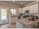 Modern kitchen with stainless steel appliances, granite countertops, white cabinetry, and an adjacent dining area at 1242 Langston Ln, Salisbury, NC 28144