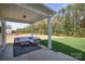 Covered patio featuring stylish outdoor furniture and a scenic view of the landscaped backyard, ideal for relaxation at 1242 Langston Ln, Salisbury, NC 28144