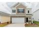 Charming two-story home featuring stone accents, a two-car garage, and a welcoming front entrance at 1248 Langston Ln, Salisbury, NC 28144