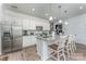 Well-lit kitchen boasts white cabinets, granite countertops, stainless steel appliances, and an eat-in island at 1248 Langston Ln, Salisbury, NC 28144