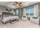 Serene main bedroom with neutral tones, a ceiling fan, large windows, and comfortable seating area at 1248 Langston Ln, Salisbury, NC 28144