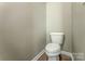 Simple and clean powder room featuring a standard toilet and neutral wall color at 1248 Langston Ln, Salisbury, NC 28144