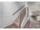 Elegant staircase with carpeted steps, wooden handrail, and decorative iron spindles, leading to the upper level at 1248 Langston Ln, Salisbury, NC 28144