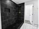 Bathroom features black tile and gold hardware at 132 Kennedy Ave, Kannapolis, NC 28083