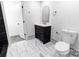 Bathroom features black vanity with gold hardware and marble tile floor at 132 Kennedy Ave, Kannapolis, NC 28083