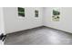 Bright, minimalist bedroom with ample natural light and wood-look flooring at 132 Kennedy Ave, Kannapolis, NC 28083