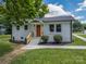 Charming single-story home with painted brick, a well-manicured lawn, and a vibrant orange front door at 132 Kennedy Ave, Kannapolis, NC 28083