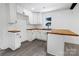 Bright kitchen featuring white cabinets, wood countertops, and stainless steel sink at 132 Kennedy Ave, Kannapolis, NC 28083