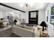 Open-concept living room features a sleek fireplace, modern lighting, and seamless flow to the kitchen at 132 Kennedy Ave, Kannapolis, NC 28083