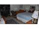 Inviting bedroom features a blue patterned quilt and wicker chair at 1325 Lee Lynn Dr # 7 Part Of 6, Albemarle, NC 28001