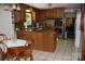Cozy kitchen with wood cabinetry, granite countertops, stainless steel oven, and tile flooring at 1325 Lee Lynn Dr # 7 Part Of 6, Albemarle, NC 28001