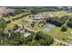 Aerial view of school complex including tennis courts, track, baseball field, and surrounded by mature trees at 137 Branchview Dr, Mooresville, NC 28115