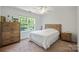 Bedroom with a neutral color scheme, window view, and wood furniture at 137 Branchview Dr, Mooresville, NC 28115