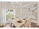 Bright dining room with marble table, statement lighting, and backyard views at 137 Branchview Dr, Mooresville, NC 28115