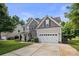 Beautiful two-story home with a stone facade, well-manicured lawn, and attached garage at 137 Branchview Dr, Mooresville, NC 28115