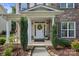 Inviting front door with a decorative wreath and charming landscaping at 137 Branchview Dr, Mooresville, NC 28115
