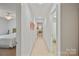 Well-lit hallway leading to bedrooms and bathrooms with neutral carpet at 137 Branchview Dr, Mooresville, NC 28115