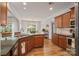 Well-lit kitchen with dark countertops, wooden cabinetry, and modern appliances at 137 Branchview Dr, Mooresville, NC 28115