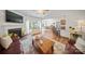 Bright living room featuring a cozy fireplace, hardwood floors, and an open floor plan at 137 Branchview Dr, Mooresville, NC 28115