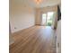 Bright bedroom with wood floors, a ceiling fan, and sliding glass doors to a balcony at 1410 4Th Street Nw Dr # 303, Hickory, NC 28601