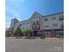 Attractive condo building with brick and siding exterior featuring balconies on a sunny day at 1410 4Th Street Nw Dr # 303, Hickory, NC 28601
