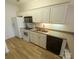Well-lit kitchen with white cabinetry and appliances, with light counter tops and stainless steel sink at 1410 4Th Street Nw Dr # 303, Hickory, NC 28601
