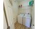 Bright laundry room with a washer, dryer, and wire shelving for convenient storage at 1410 4Th Street Nw Dr # 303, Hickory, NC 28601