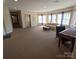 Bright, open-concept living room with carpeting and large windows at 1410 4Th Street Nw Dr # 303, Hickory, NC 28601
