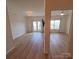 Open-concept living area with wood floors and access to a balcony at 1410 4Th Street Nw Dr # 303, Hickory, NC 28601