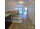 Open-concept living area with wood floors, leading to a balcony, and a built-in bar area at 1410 4Th Street Nw Dr # 303, Hickory, NC 28601