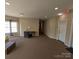 Spacious lobby area with neutral walls and floors, a small desk and chair, and an exit sign at 1410 4Th Street Nw Dr # 303, Hickory, NC 28601