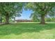 Inviting brick home framed by mature trees and a lush green lawn at 14411 Eastfield Rd, Huntersville, NC 28078