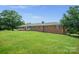 A charming, single-story brick home featuring a covered front porch and manicured lawn, blending classic style with curb appeal at 14411 Eastfield Rd, Huntersville, NC 28078