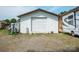 Detached garage featuring white siding, providing ample storage or workspace, next to recreational vehicle at 14411 Eastfield Rd, Huntersville, NC 28078