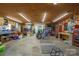 Spacious garage workshop with wood paneled walls, tools, and ample lighting, perfect for projects and hobbies at 14411 Eastfield Rd, Huntersville, NC 28078