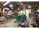 Large garage workshop with a tractor and tools, offering ample space for equipment and storage at 14411 Eastfield Rd, Huntersville, NC 28078