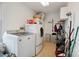 Efficient laundry area with white, front-load washer and dryer; organized with storage shelves and cleaning supplies at 14411 Eastfield Rd, Huntersville, NC 28078