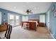 Spacious primary bedroom featuring blue walls, French doors, and a ceiling fan at 14411 Eastfield Rd, Huntersville, NC 28078