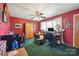 Charming home office featuring red walls, natural light, and ample desk space at 14411 Eastfield Rd, Huntersville, NC 28078