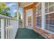 Outdoor balcony area with a brick exterior, white railing, and green flooring at 14624 Via Sorrento Dr # 6206, Charlotte, NC 28277